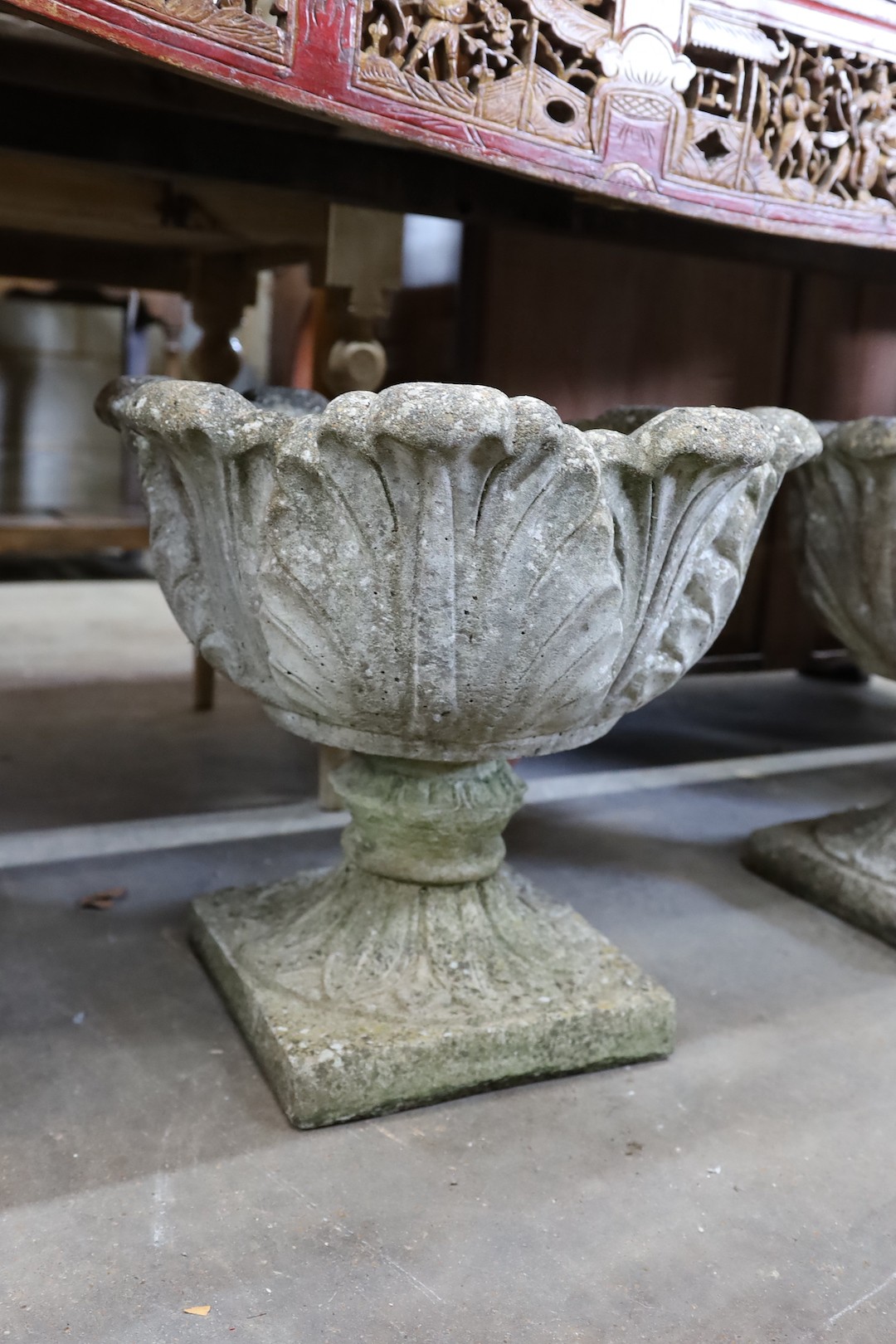 A pair of circular reconstituted stone garden planters moulded with acanthus leaves, diameter 50cm, height 43cm